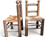 pair of wooden chairs with rope seat and backrests
