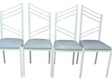 three white chairs with blue upholstered seats on a white background