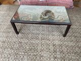 a glass table with a snake on it in a living room