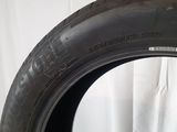 an image of a tire on a white surface with a white curtain behind it
