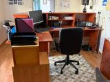 a desk with a chair and a laptop on it
