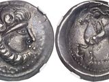 a close up of a silver coin with a woman on it