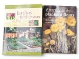 two books of plants and flowers on a white surface