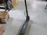 a scooter that is sitting on the floor in a store