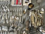 many spoons, forks, spoons and spoon spoons on the table