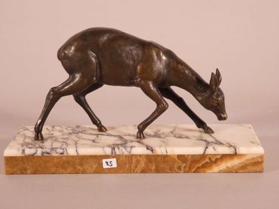 bronze sculpture of a deer on a marble base
