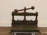 a small green bench with a baseball bat on top of it