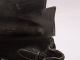 someone is holding a black leather purse with a zipper on the inside