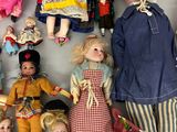 a lot of dolls that are laying on the floor