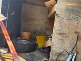 an image of a garage with a ladder and a pile of junk
