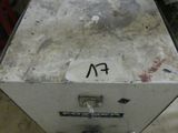 a metal box with a sign on it in a garage