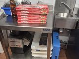 a metal table with a bunch of pizzas on it