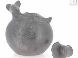 an image of a black stone vase and a small piece of stone
