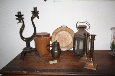 a wooden table topped with antique items on top of it