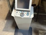a machine that is sitting on the floor next to a chair