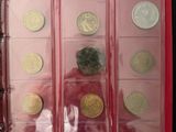 a lot of coins in a red case on a table