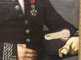 portrait of a man in a military uniform holding a book