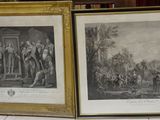 two framed prints of a couple of men standing next to each other
