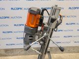 a machine that is sitting on a stand in front of a wall