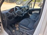the interior of a white van with black seats and a steering wheel