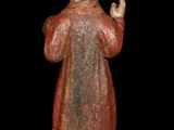 statue of a man in a red robe holding his hands up