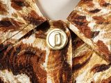 an image of a close up of a shirt with a button on it
