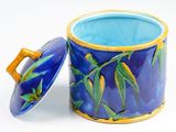 a blue cup with a lid sitting on a white surface