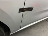 a sticker on the side of a silver car