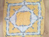 a yellow and white square with blue chains on it