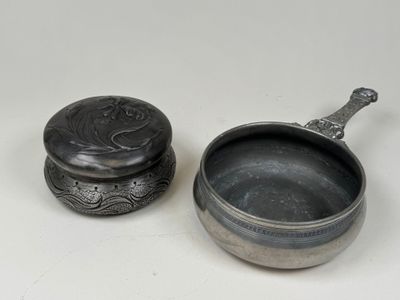 pair of silverplated bowls with lids and spoons on a white surface