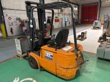 a forklift in a warehouse with a lot of equipment