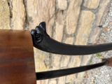 a close up of a wooden bench with a metal handle