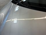 a close up of a car ' s hood with the sun shining on it