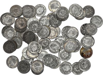 a close up of a pile of silver coins on a white surface