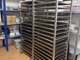 many trays of food on the shelves in the kitchen