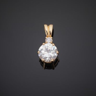 a diamond pendant on a black surface