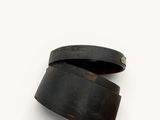 a close up of a pair of black leather cuff bracelets on a white surface