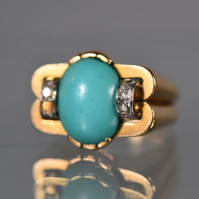 une image représentant une bague en or sertie d'une turquoise et de diamants
