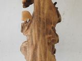 a wooden vase that is sitting on a white surface