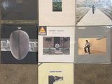 several albums are stacked on top of each other on the floor