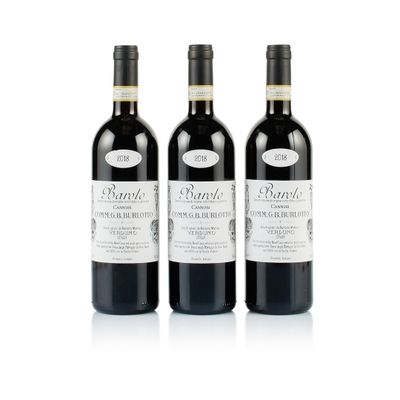 trois bouteilles de vin rouge posées l'une à côté de l'autre sur une surface blanche