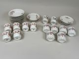 a lot of plates and cups that are sitting on a table