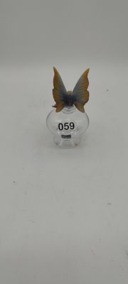 a small butterfly sitting on top of a clear object