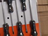 four black and orange screwdrivers in a package on top of a cardboard box