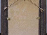 an old wooden frame with a picture hanging on it ' s side