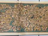 an old map of a city on a tile wall