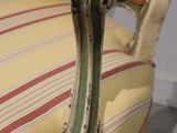 striped upholstered chair with wooden legs and arms