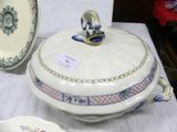 a white table with a bowl and a plate on it