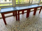 three tables that are sitting on the floor in front of a window