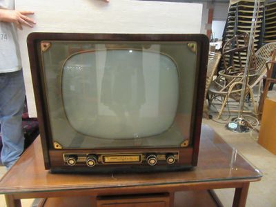 an old television sitting on top of a wooden table